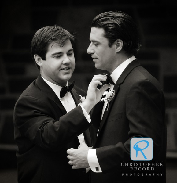 Groomsman gets an assist with his tie prior to the ceremony