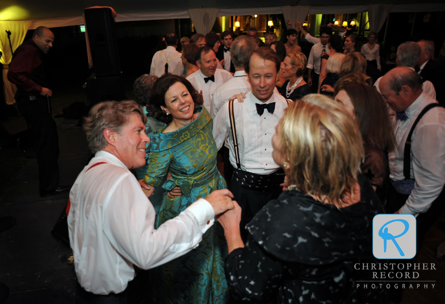 Lucy's dad and mom dance with friends