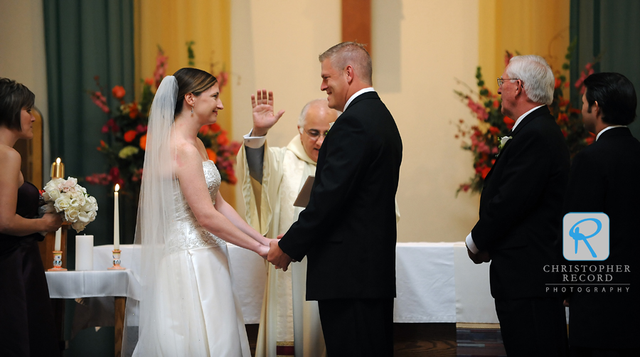 The Monsignor Richard Bellow blesses the couple