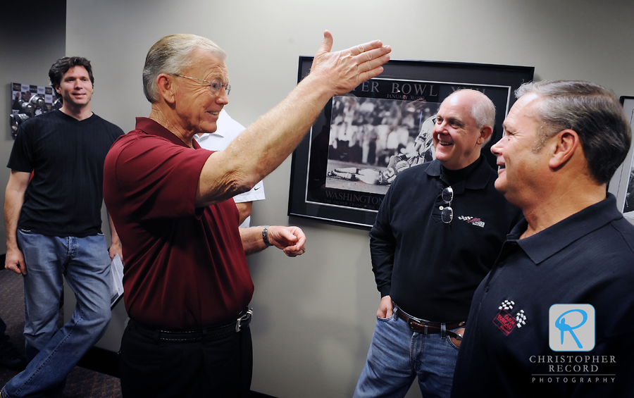 NASCAR race team owner and former NFL Coach Joe Gibbs, left, chats with Farm Bureau Insurance executives Tommy Doolittle, center, and Buddy Trosclair prior to filiming a commercial this week