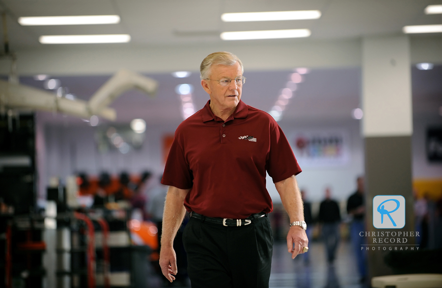 Gibbs makes his way through the Huntersville shop of his race team