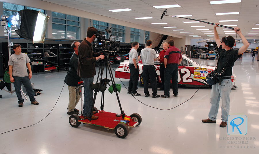 The crew films in the race shop