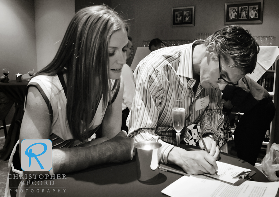 Hosts Meredith and Walter bid on a silent auction item