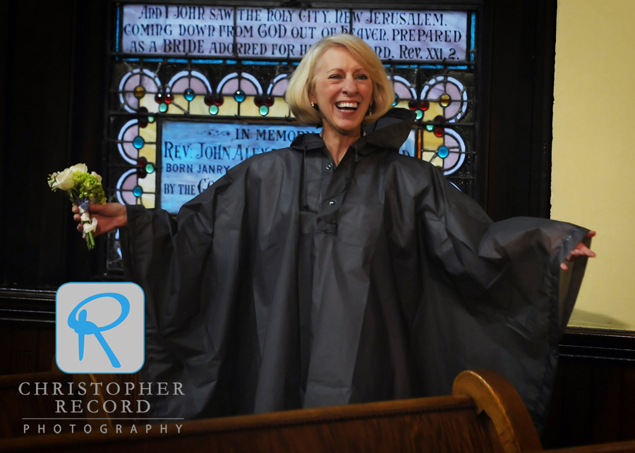 Brant's mother broke out a poncho to try to stay dry on her way to the reception