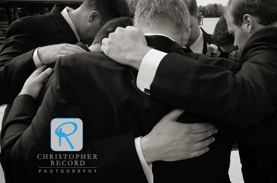 The men pray before heading to the ceremony