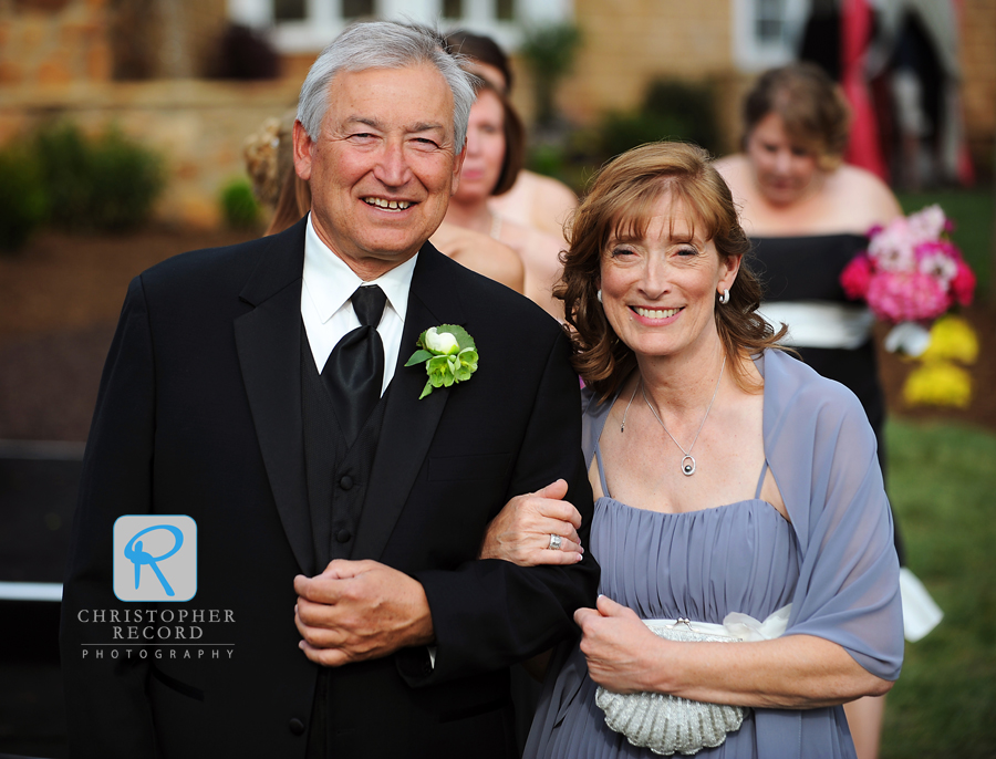 Alison's parents walk out to the outdoor ceremony