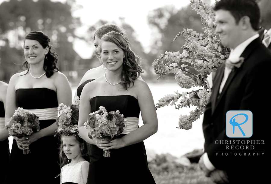 The bridesmaids watch David's reaction as Alison comes down the aisle