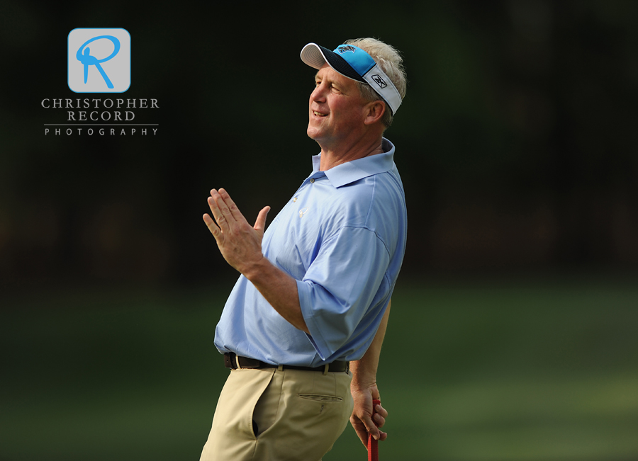 Carolina Panthers coach John Fox reacts after barely missing a putt during the Pro-