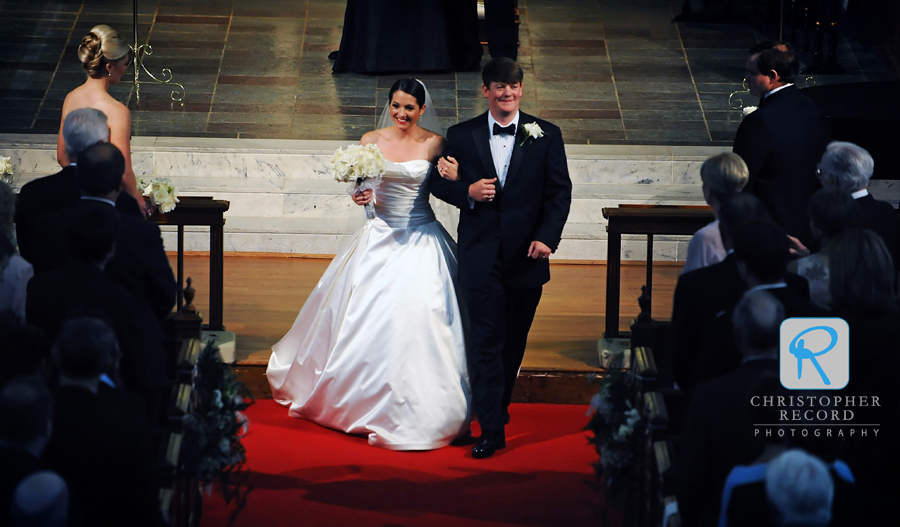 Elizabeth and Taylor smile at their families as they leave the church