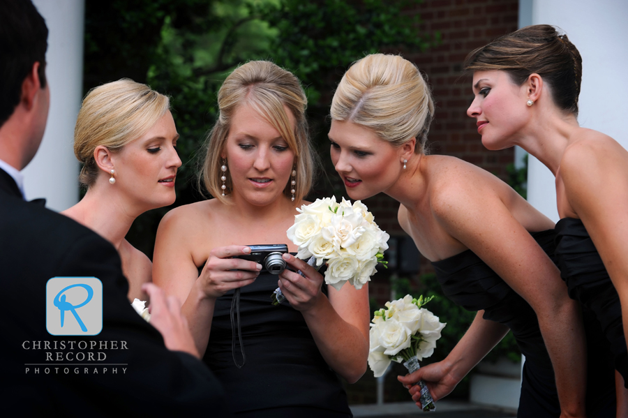 The bridesmaids check their photo skills