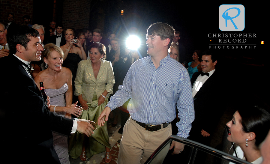 Elizabeth's brother Chuck congratulates Taylor as the families send them off