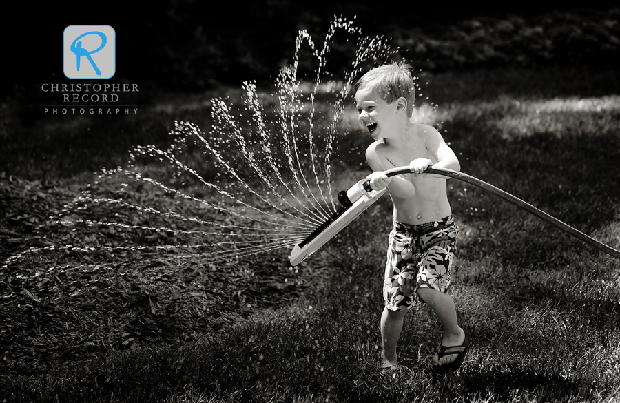 Callan tries to chase his dad down with the sprinkler