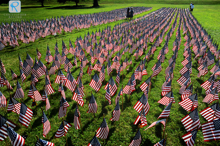 Children walk among some of the 2,997 American flags used to represent the twin towers