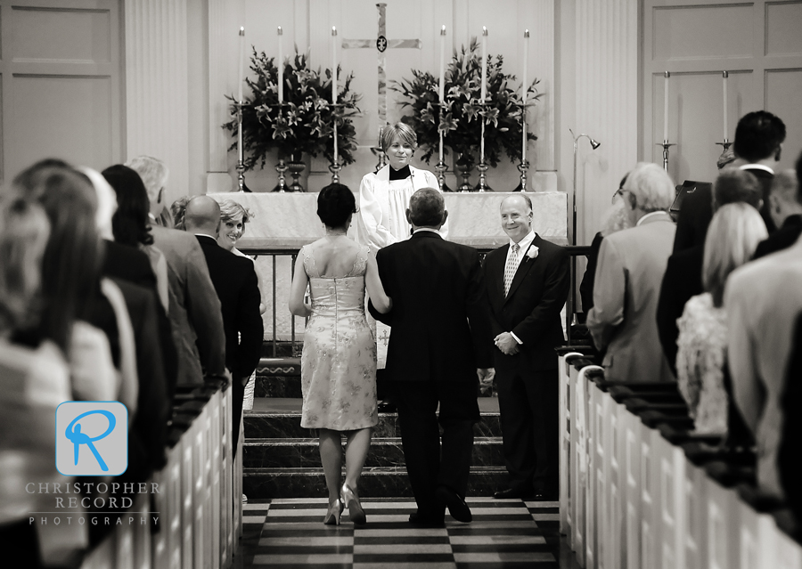 Jim watches his bride as she approaches the altar