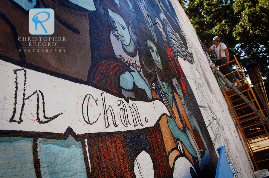 William Puckett works on his mural in NoDa