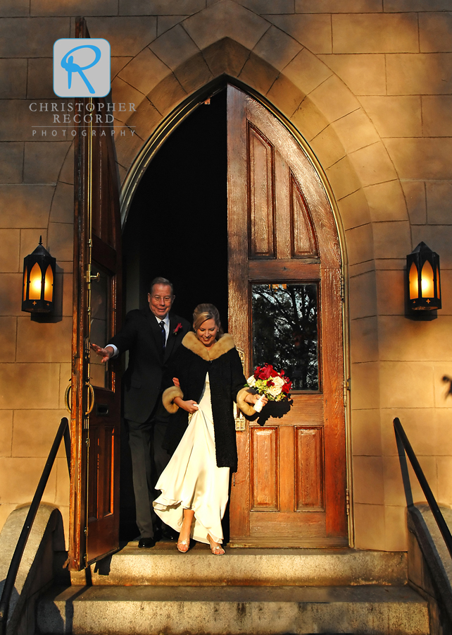 Late-afternoon sun warms the scene as Carolyn and her father walk to the front of the church