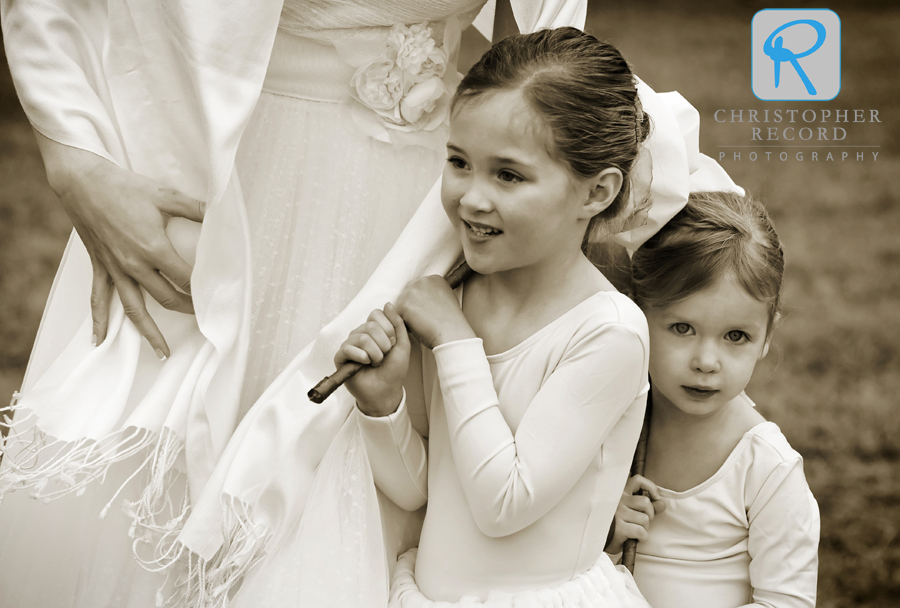 Liz helps keep the flower girls warm while pictures are taken