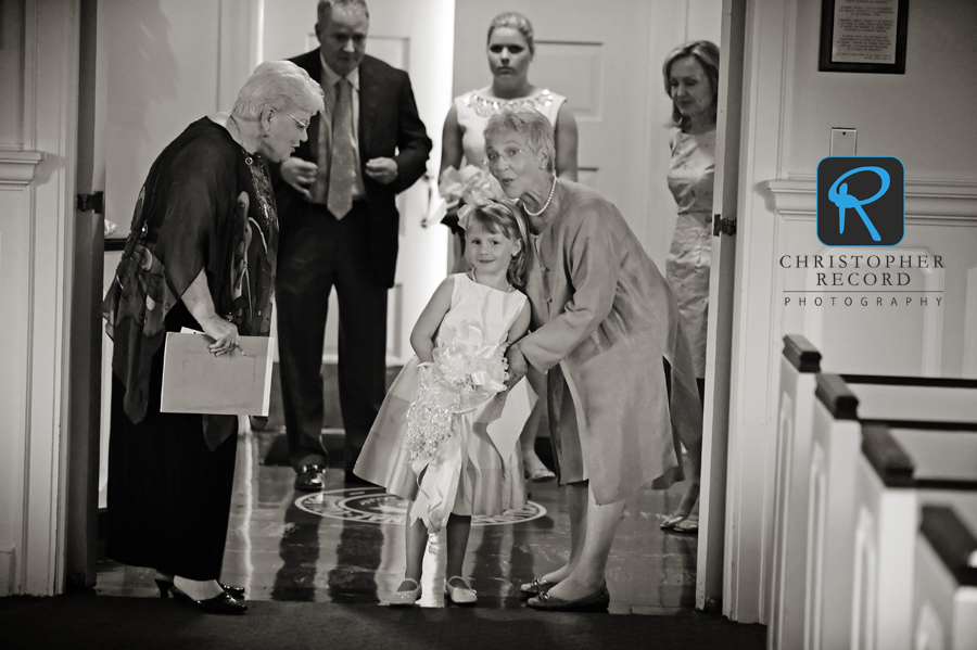 Family friend Anne, left, and Elizabeth's grandmother, Varion, give pointers to flower girl Kendall