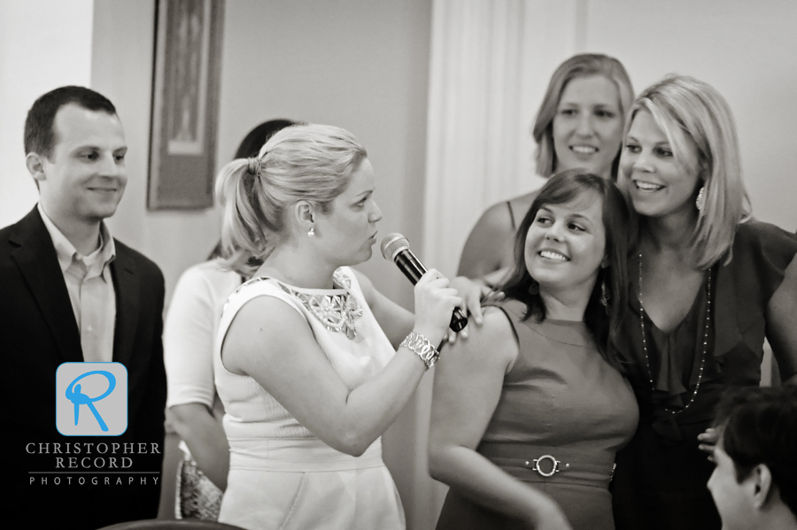 Brad looks on as Elizabeth jokes with her sister Denard, center, and Brad's sister Katie