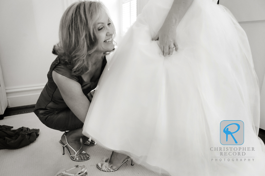 Amy helps her daughter with her shoes