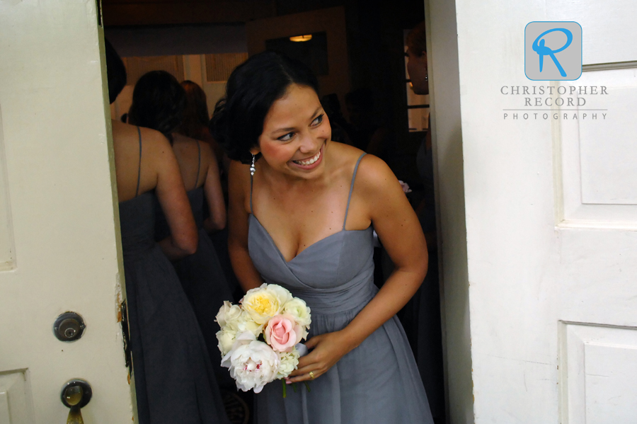 The doorway was a popular spot as a bridesmaid sneaks a peak at Elizabeth