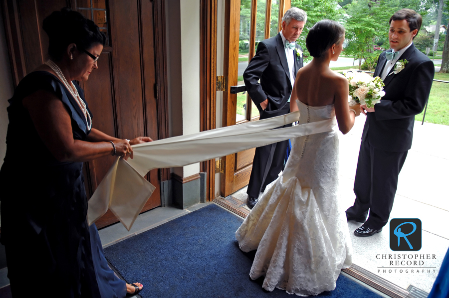 Tanner's mother fixes her dress as her father Bob and Sam look on