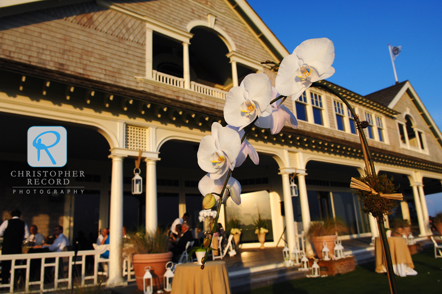 Light paints the flowers and clubhouse as the reception gets underway