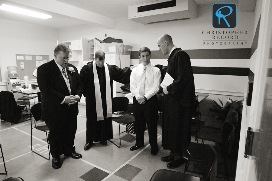 Byers and his father Johnny, far left, pray with the ministers prior to the service