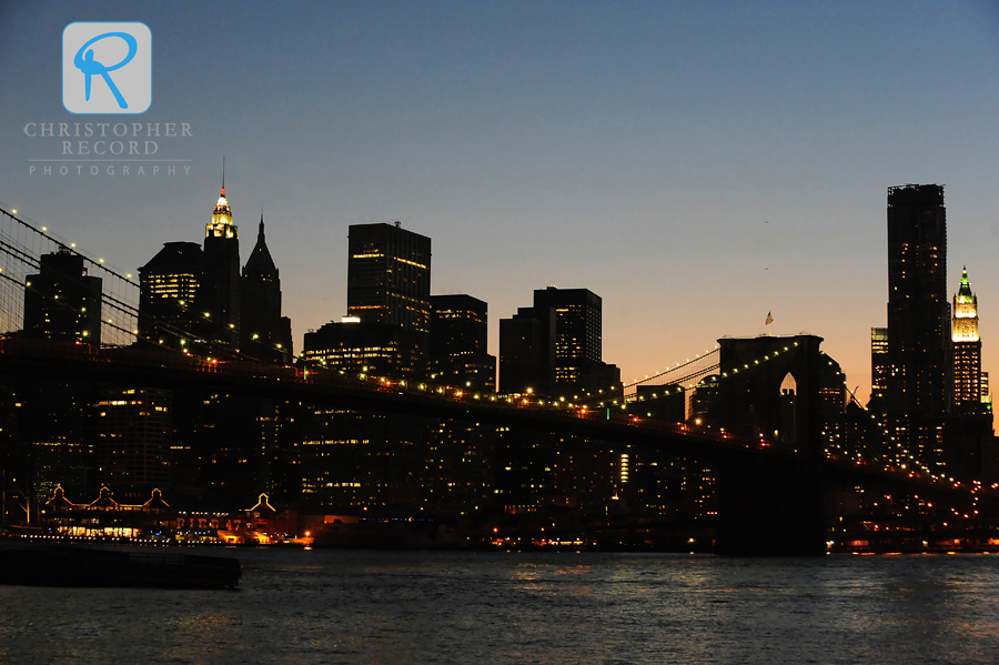 The Brooklyn Bridge frames Manhattan at twilight