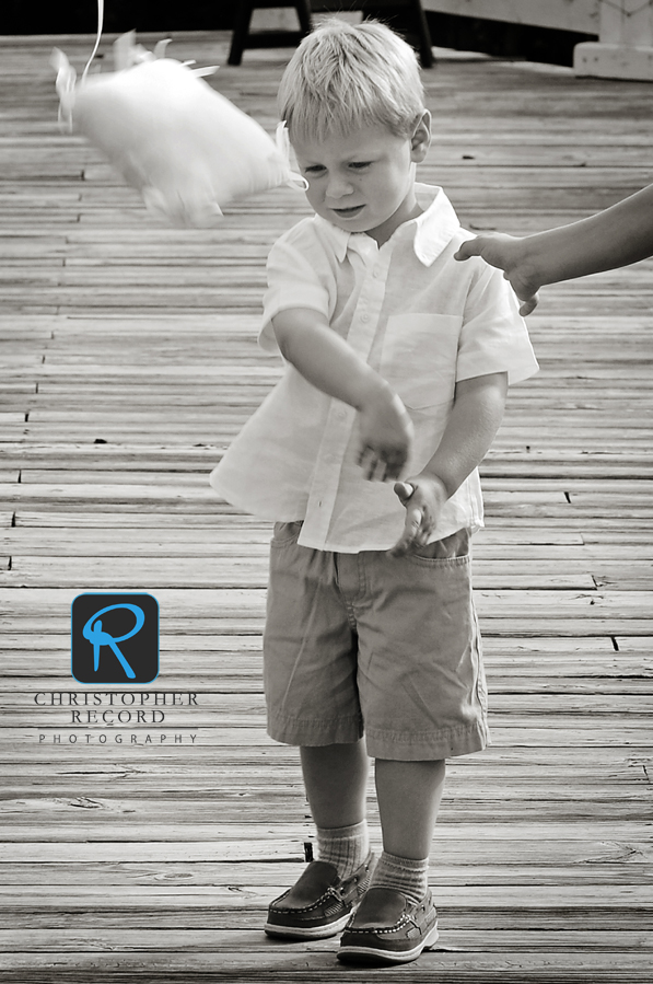 The first ring bearer decided he wasn't going to carry his pillow - so he flung it down the aisle