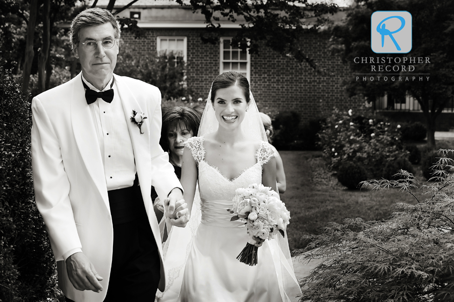 The bride and her father enter the church