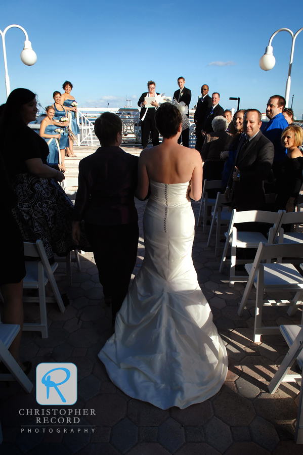 Kristina's mother walks her to the ceremony