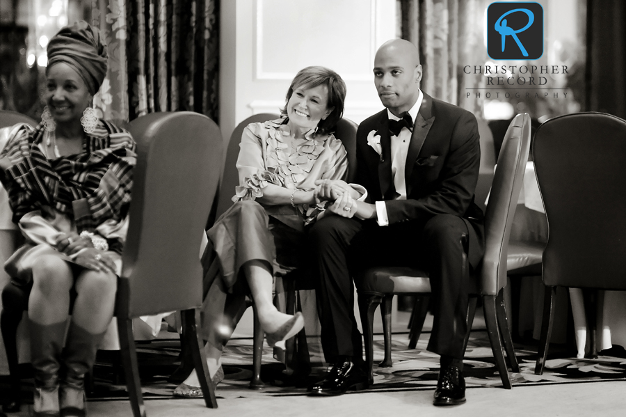 Quentin sits with Leignton's mother as they watch the father-daughter dance