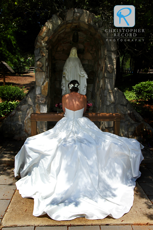 Amy pauses to pray before the services at St. Gabriel Catholic Church