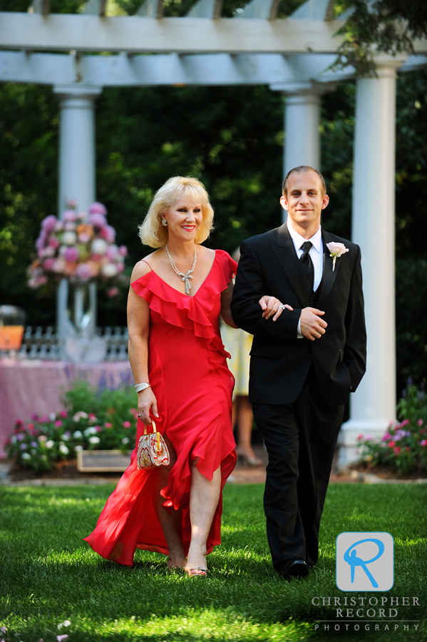 Graham escorts his mother to her seat