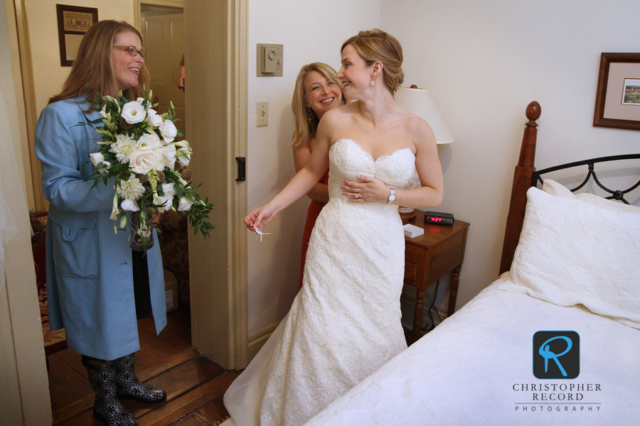 April Greenwood, a close family friend who also worked as their event planner, greets Regina and her sister Ticia