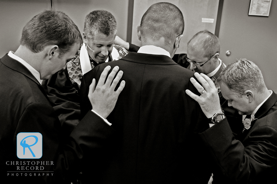 Michael's brother and brother-in-law and ministers Mitch White and Mike Moses gather to pray