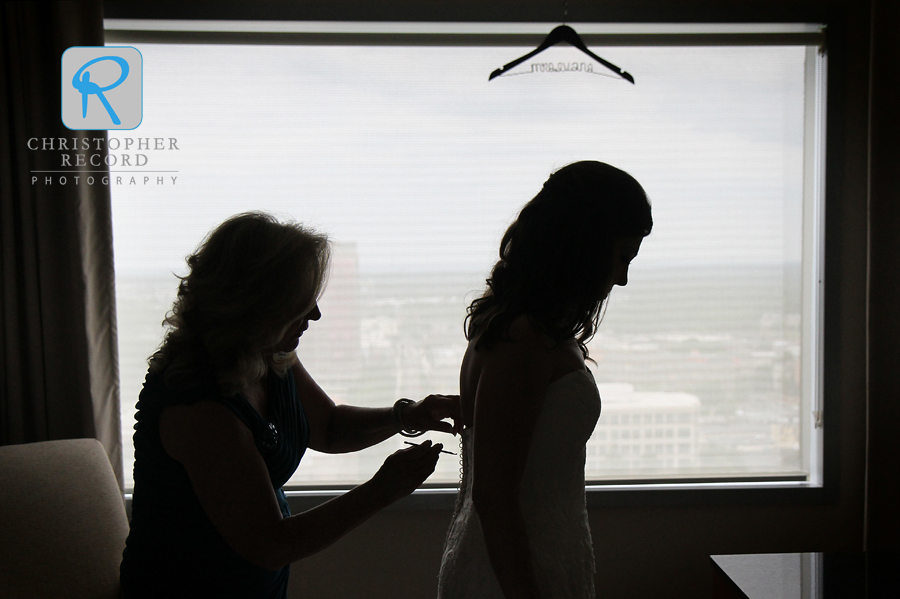 Vanessa's mother helps with the dress