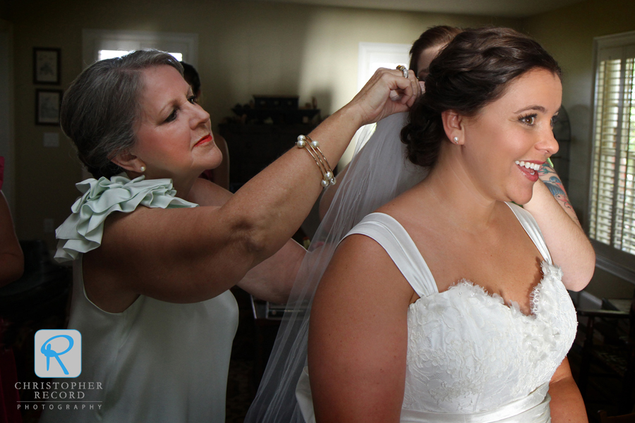 Sherry places the veil on her daughter