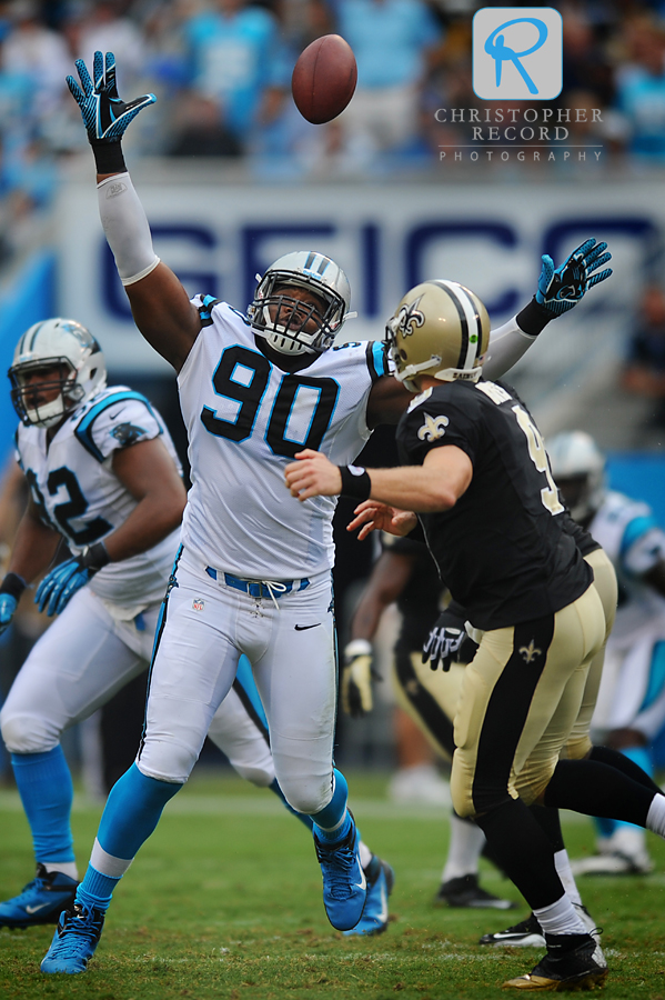 Panther Frank Alexander (90) knocks down a Drew Brees pass