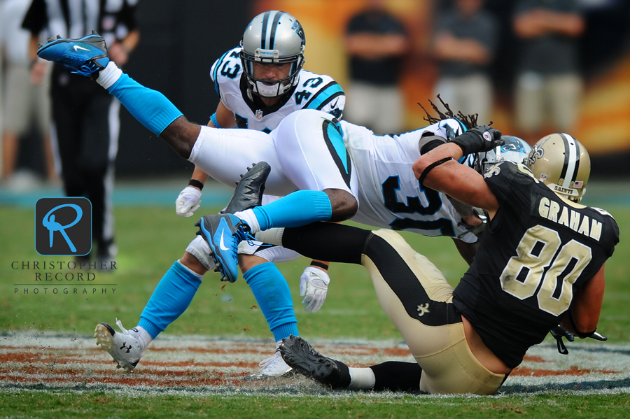 Carolina's Charles Godfrey puts a big hit on Saint receiver Jimmy Graham