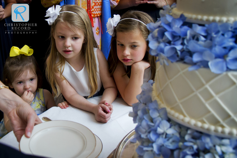 The flower girls gave the cake their full attention