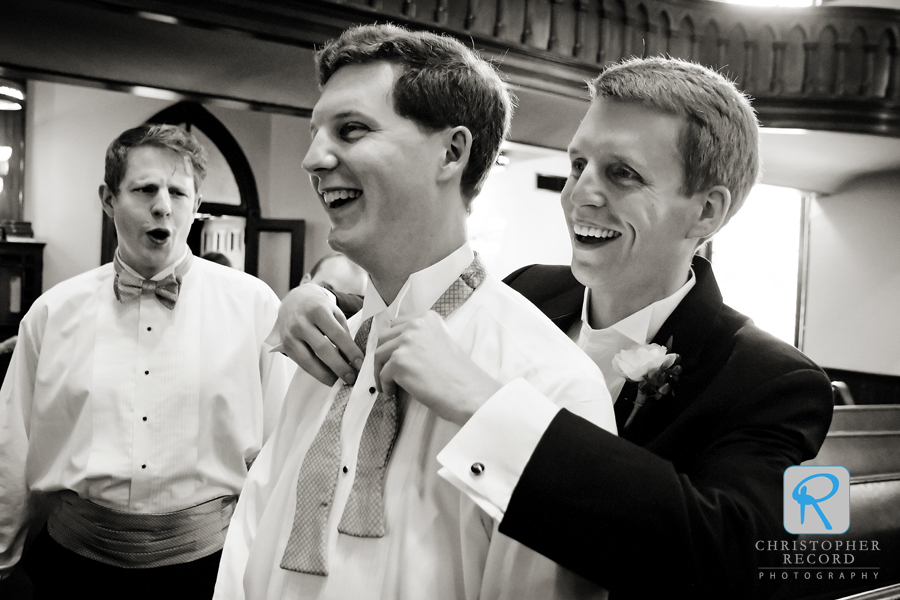 Claire's brother Peter looks on as Bill helps his brother John with his tie