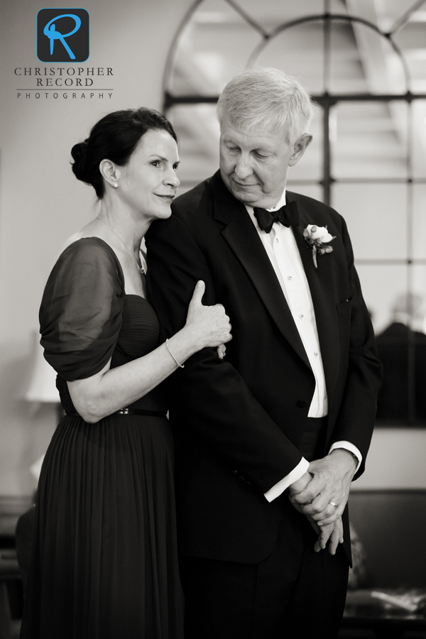 Claire's parents, Lili and Chris, share a moment after seeing their daughter in her dress