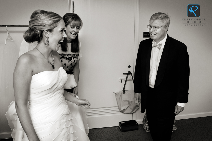 Sarah Dorsett's father Ken gets a glimpse of the bride as her mother Rush looks on