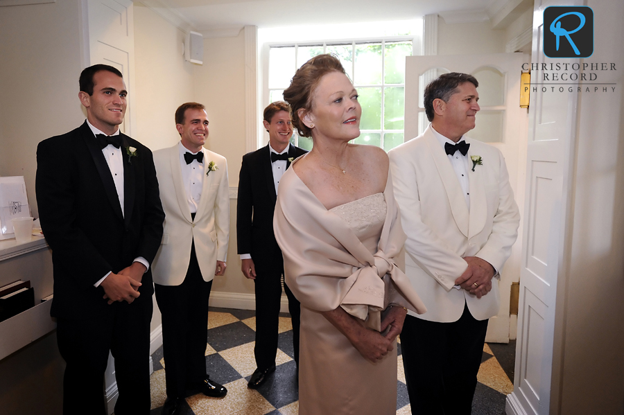 Joseph, with his parents and brothers, watches guests arrive